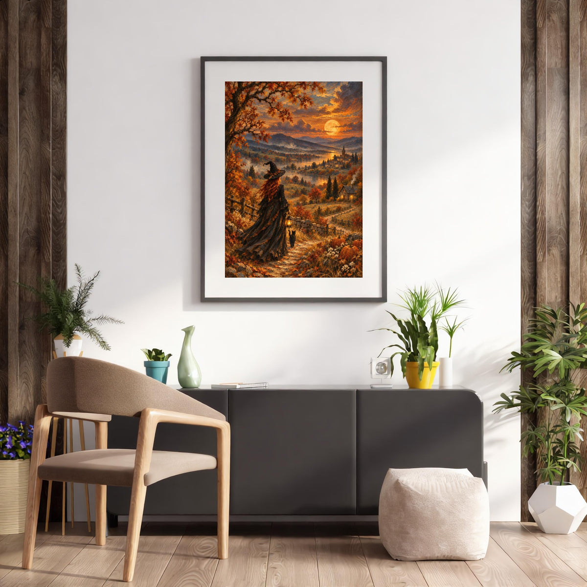 Mystical witch wall art displayed above a modern kitchen countertop with wooden cabinets and a black pendant light. The vintage-style painting features a golden harvest moon, autumn forest, and enchanting countryside scenery.