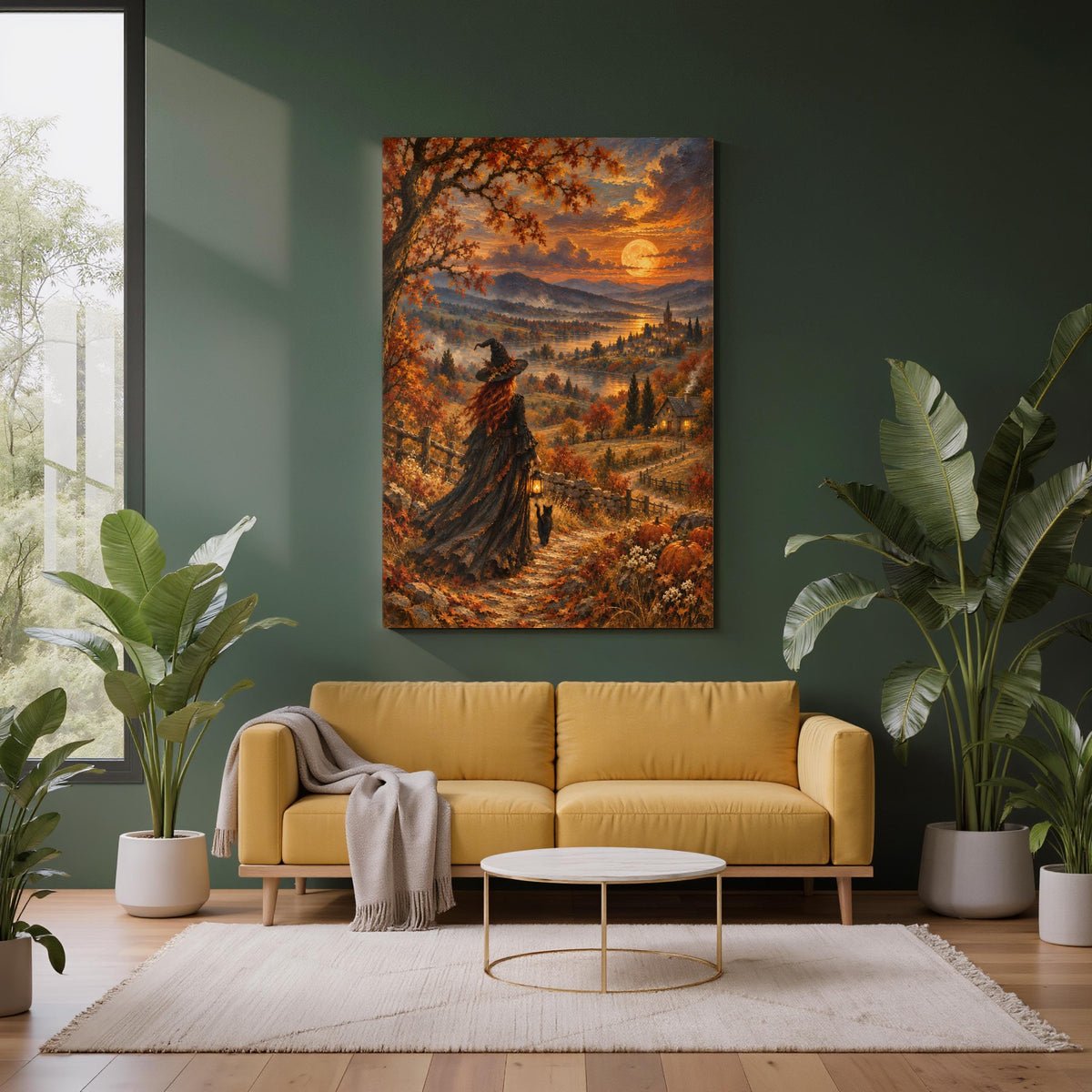 Mystical autumn witch wall art displayed above a mustard-yellow sofa against a dark forest green accent wall. The vintage-inspired landscape painting features a red-haired witch in a flowing black gown walking with her black cat and glowing lantern beneath a golden harvest moon. Large leafy houseplants and neutral furnishings complement the warm orange fall scenery.