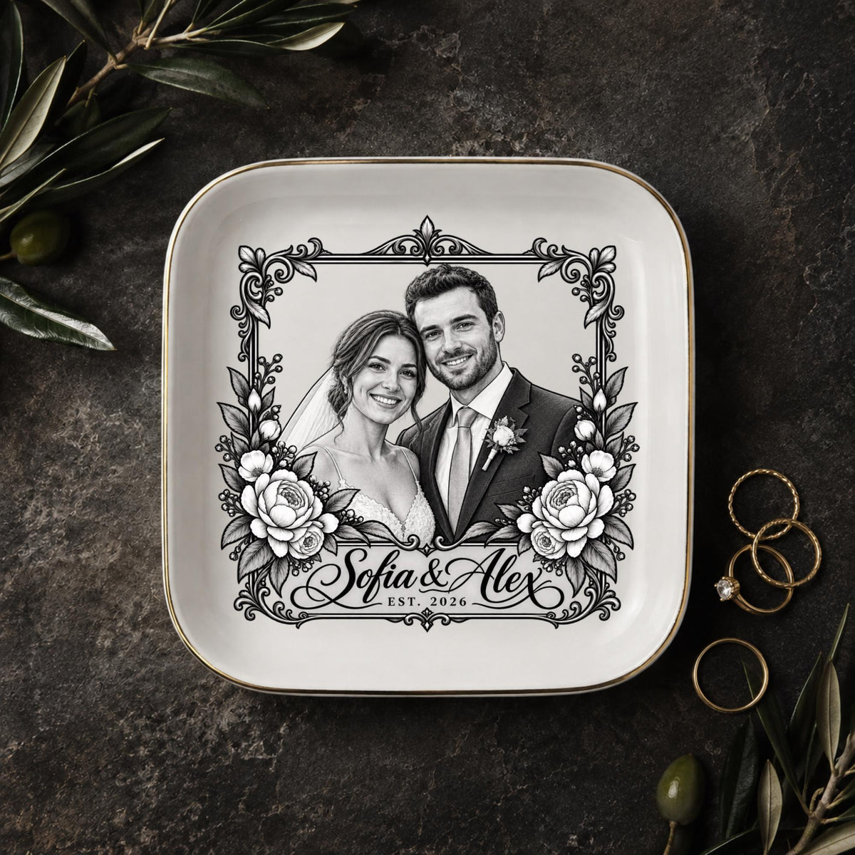 Personalized wedding jewelry dish featuring a black-and-white couple portrait, ornate floral frame, custom names, and wedding year on a square ceramic dish with gold trim.