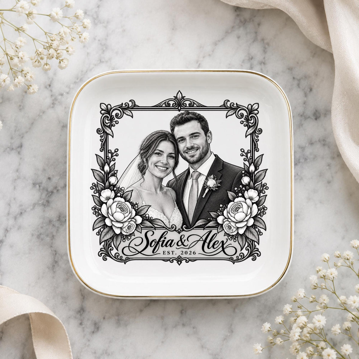 Custom couple portrait ring dish displayed on a soft marble surface with delicate neutral styling and gold-edged ceramic details.