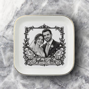 Custom bride and groom keepsake dish shown on a soft neutral fabric background with a black-and-white portrait, floral frame, names, and wedding year.