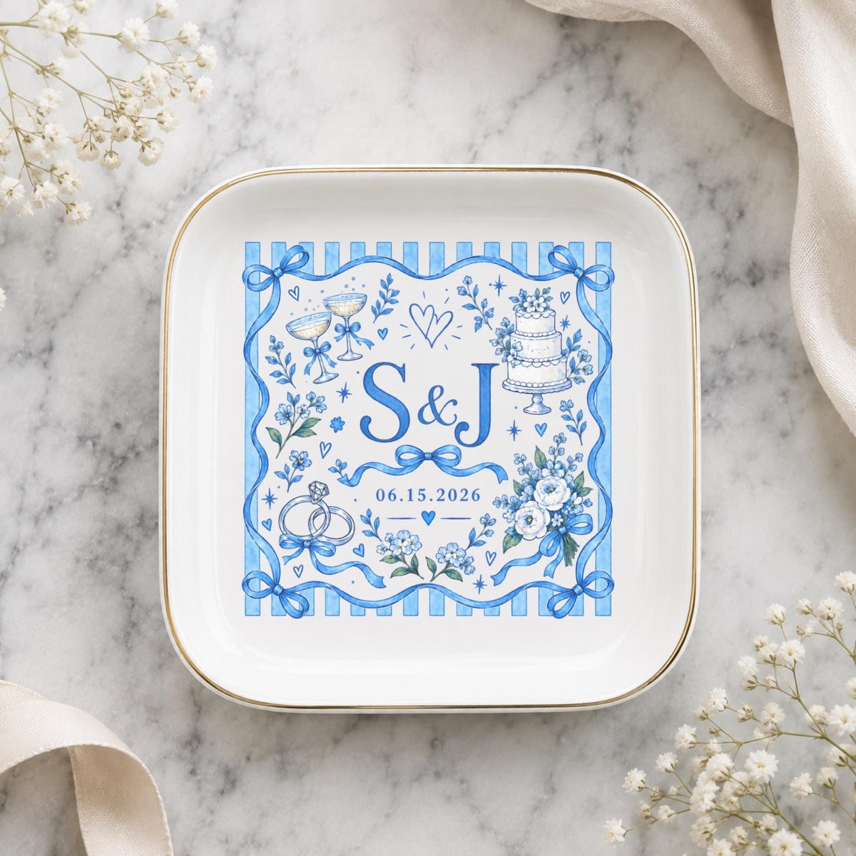 Custom initials ring dish displayed on a soft marble background with delicate neutral styling and a blue personalized wedding design.