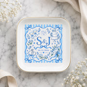 Custom initials ring dish displayed on a soft marble background with delicate neutral styling and a blue personalized wedding design.
