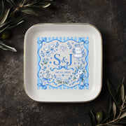 Personalized ring dish displayed on a dark elegant surface with greenery, featuring a blue floral border, custom initials, and wedding date.