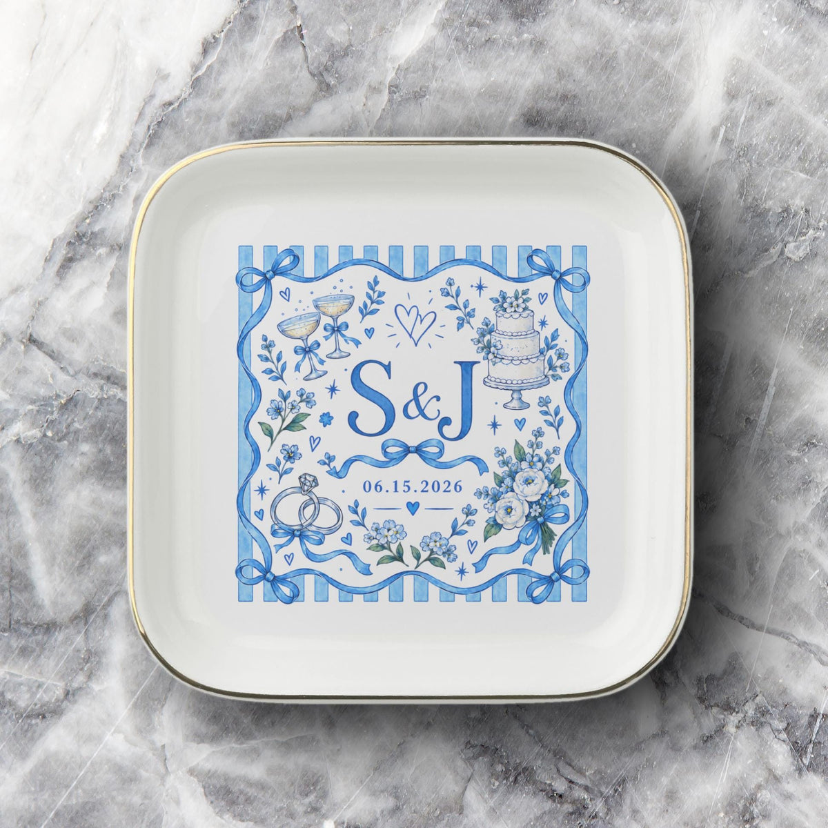 Custom couple keepsake dish shown on a soft neutral fabric background with blue botanical artwork, bows, personalized initials, and gold edging.
