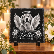 Square pet memorial slate mockup showing a custom dog portrait with angel wings, flowers, personalized name, and dates displayed on a wooden stand.