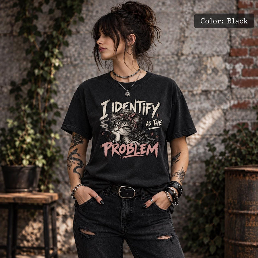 Black Comfort Colors 1717 T-shirt featuring a grumpy cat in a bandana with the quote “I Identify as the Problem” in distressed cream and pink lettering.