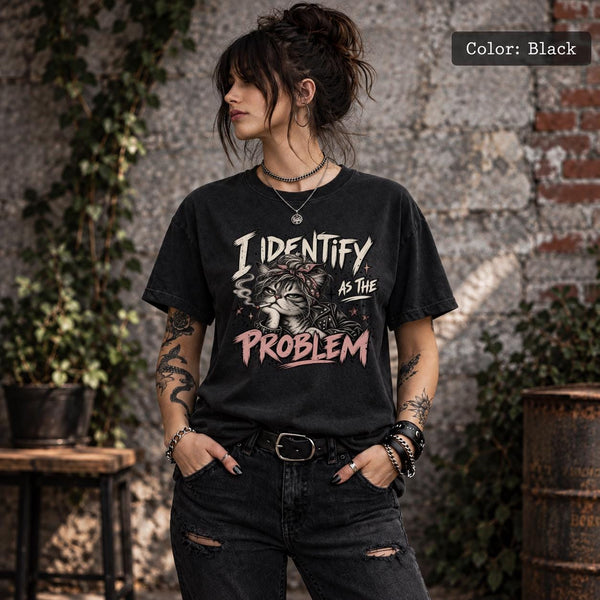 Black Comfort Colors 1717 T-shirt featuring a grumpy cat in a bandana with the quote “I Identify as the Problem” in distressed cream and pink lettering.