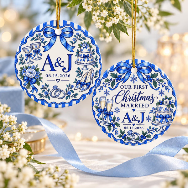 Two personalized blue and white porcelain-style wedding Christmas ornaments featuring custom initials, wedding date, floral details and elegant blue bows, displayed with soft flowers and satin ribbon.