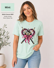 Mint Bella+Canvas T-shirt showing the feminine billiards artwork with crossed cues, heart shape, bow, and 8 ball centerpiece.