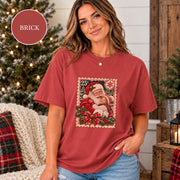Brick Comfort Colors shirt featuring the personalized Santa photo design with a child, red plaid ribbon, holly accents, snowy background, and vintage holiday styling.