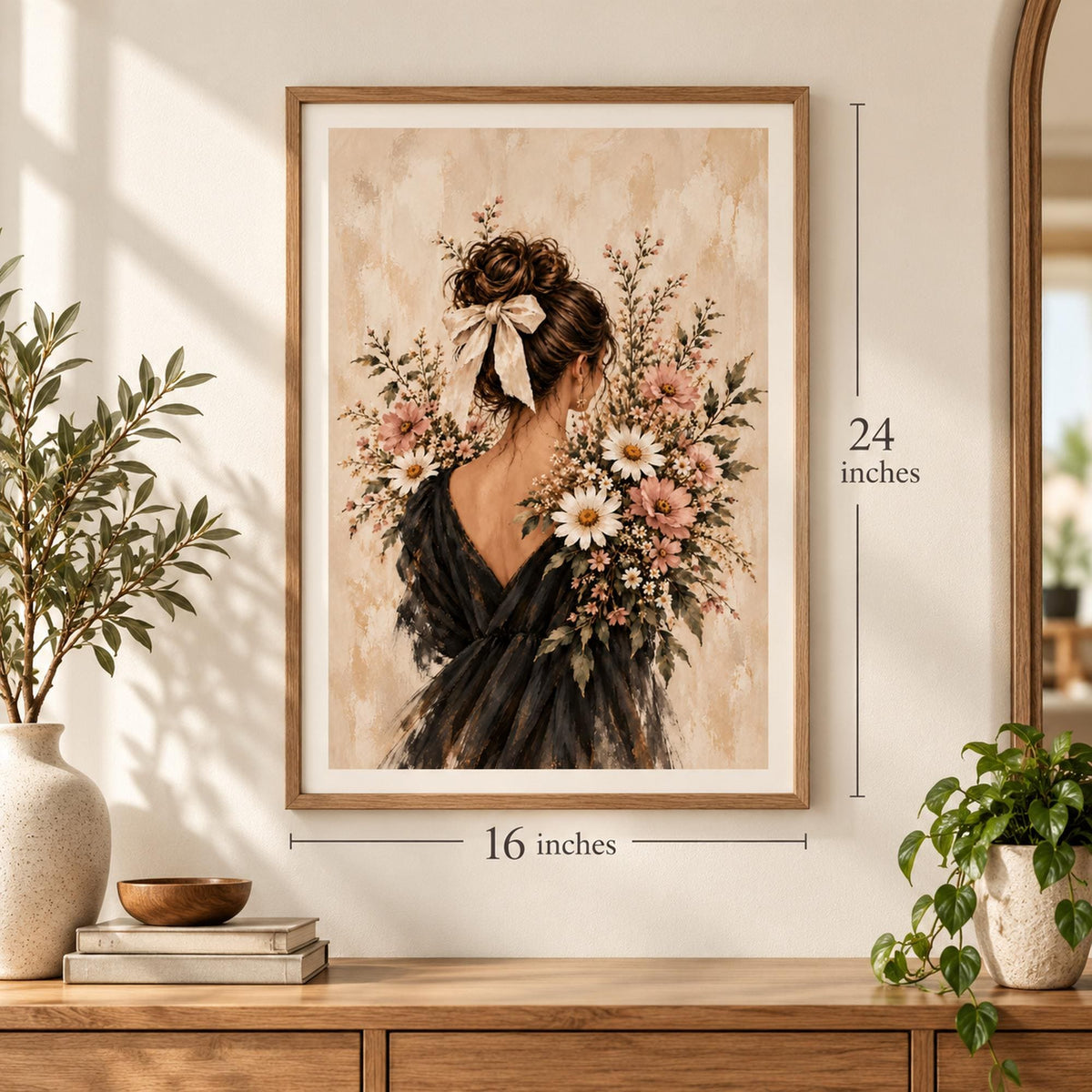 16 x 24 inch framed botanical wall art displayed above a wooden console with decorative plants. The romantic feminine portrait features a woman in a dark dress with an ivory hair ribbon, surrounded by blush pink flowers, white daisies, and soft beige painterly textures.