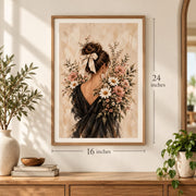 16 x 24 inch framed botanical wall art displayed above a wooden console with decorative plants. The romantic feminine portrait features a woman in a dark dress with an ivory hair ribbon, surrounded by blush pink flowers, white daisies, and soft beige painterly textures.