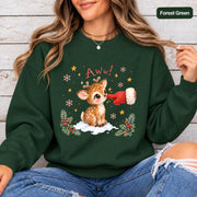 Forest Green Gildan 18000 crewneck displaying the cute Christmas reindeer artwork with red mitten, snowflakes, golden stars, and festive evergreen accents.