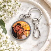Personalized photo keychain styled with delicate flowers and soft neutral decor, featuring a couple portrait at sunset.