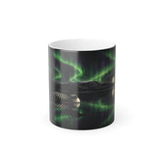 Printify product mockup of the 11 oz black colour-changing mug printed with a loon on a still lake reflecting green northern lights and a full moon
